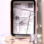 Nikolay sewing kit with instructions and tools on a white background