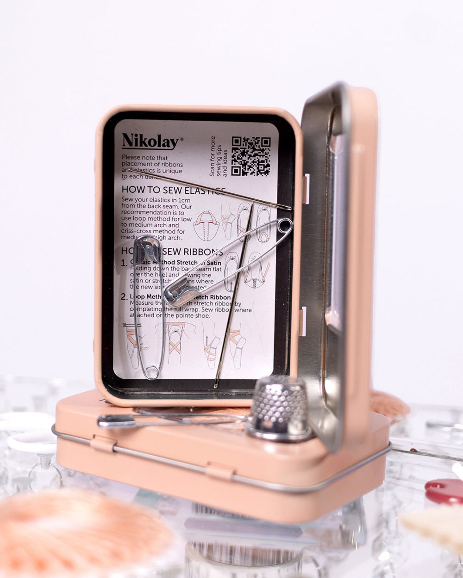 Nikolay sewing kit with a clear lid showing instructions on a white background