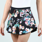 Floral patterned skirt worn by a person on a light gray background