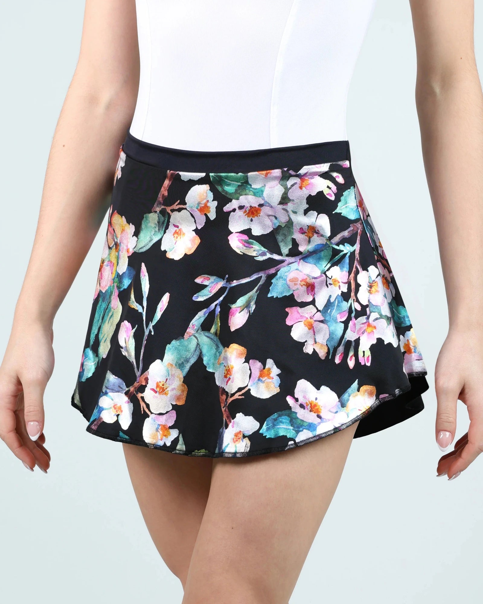 Floral patterned skirt worn by a person on a light gray background