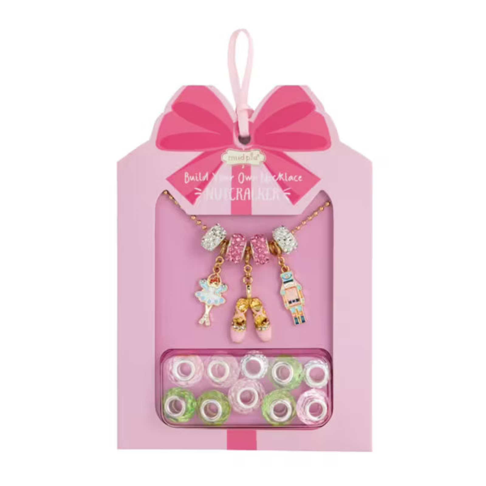 A pink gift-box style jewelry kit package with a hanging ribbon, showing a gold necklace with colorful charms and a tray of assorted beads inside a pink card.