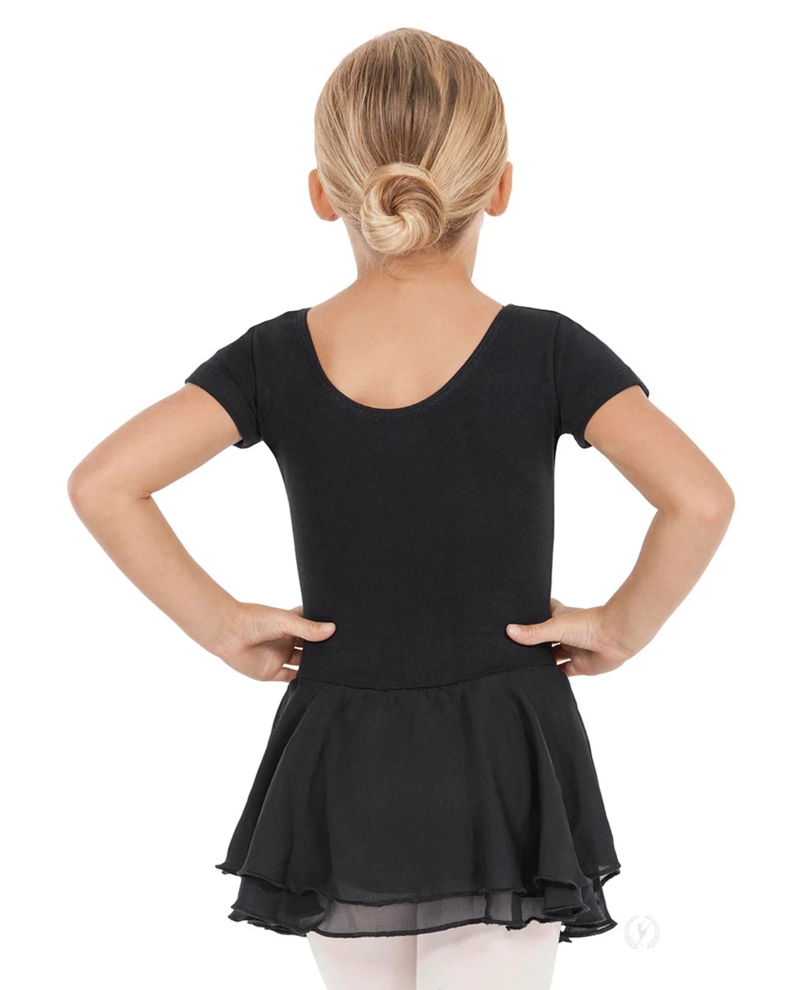 Young girl wearing a black dress with a sheer overlay on a white background