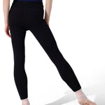 Person wearing a navy leotard and black sweater tights on a white background