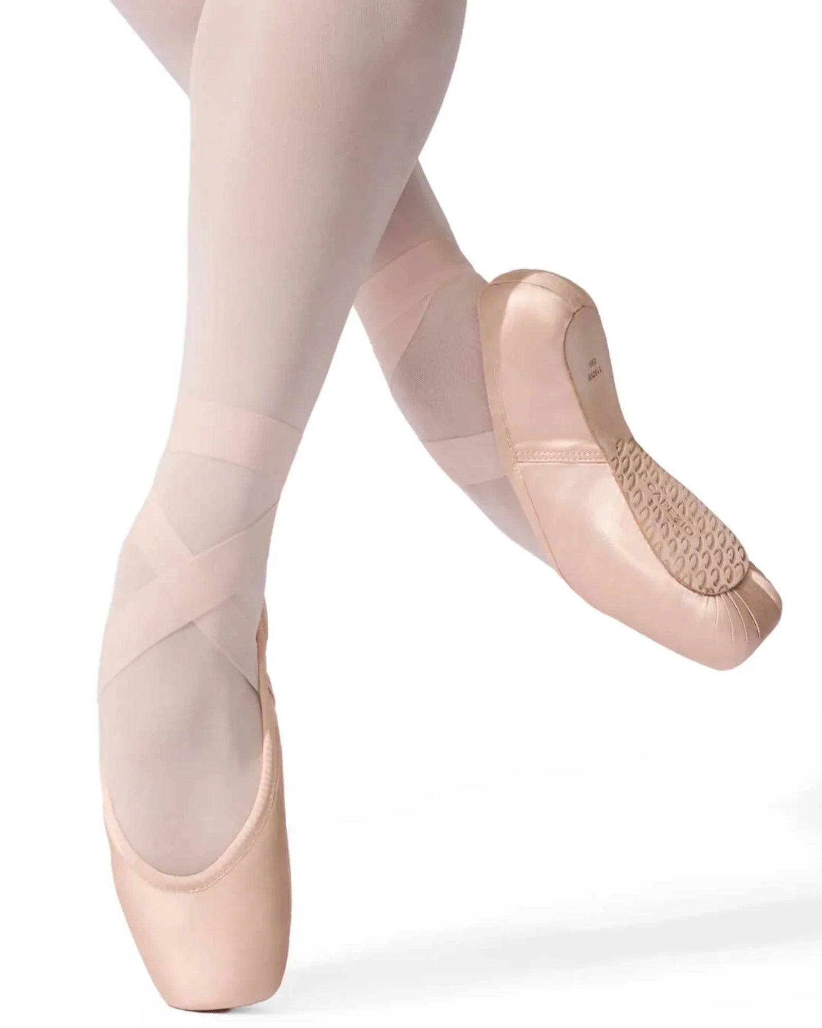 Pointe shoes worn with tights on a white background