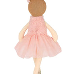 Toy doll with a pink dress and brown hair bun on a white background