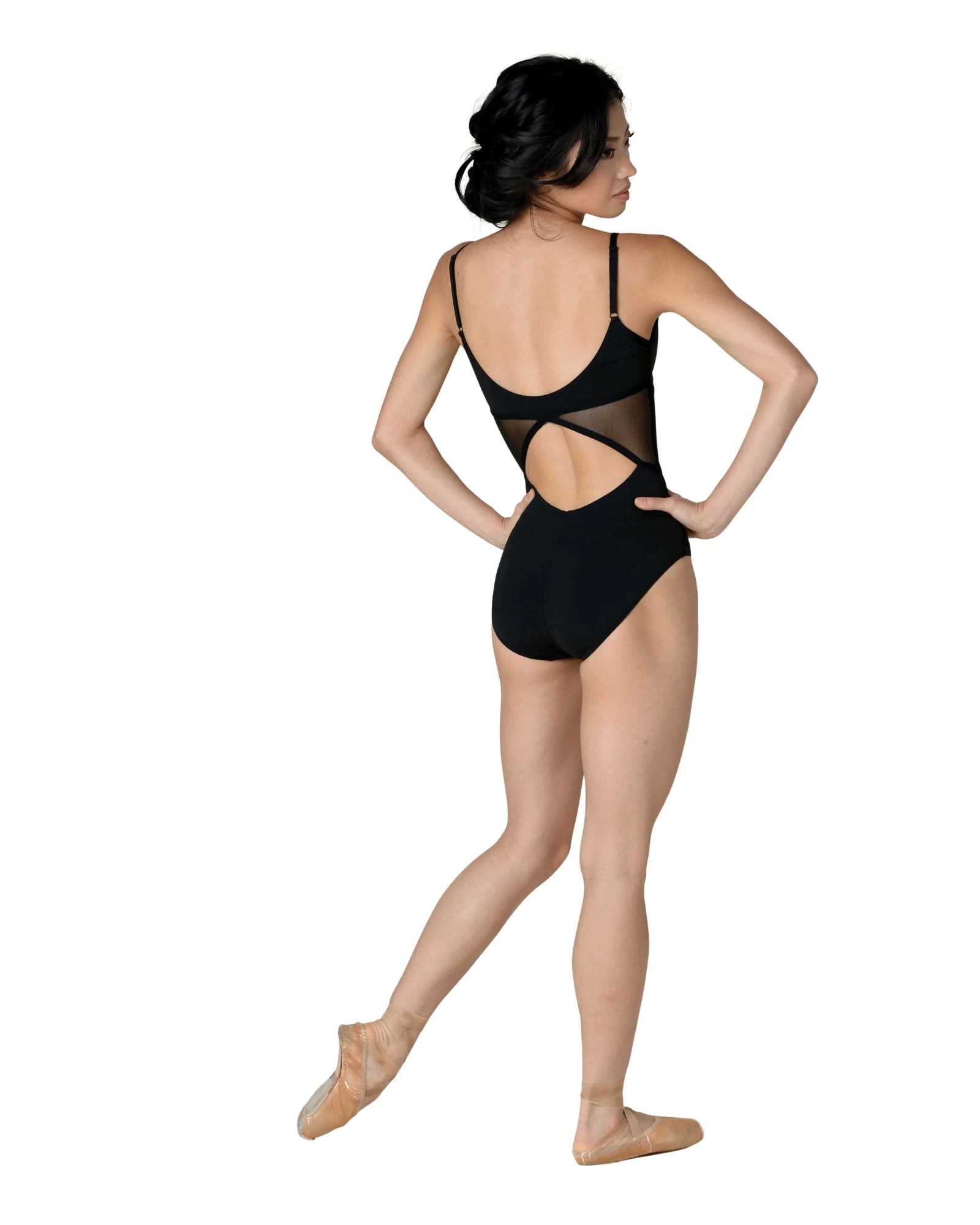 Dancer wearing a black leotard with cut-out design on a white background