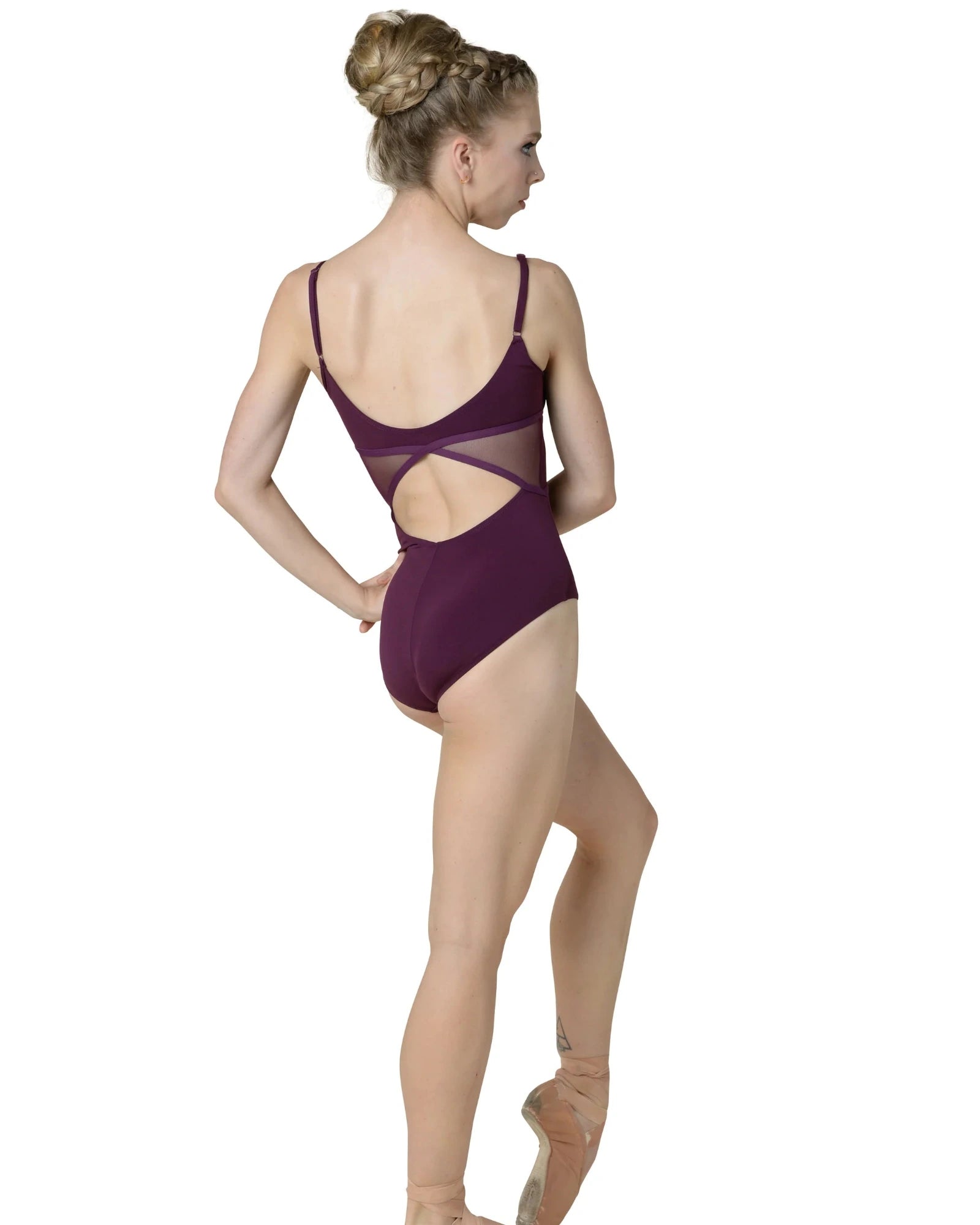 Dancer wearing a maroon leotard on a white background