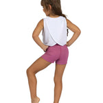 Person wearing a white sleeveless top and pink shorts on a white background