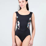 Woman wearing a black leotard with floral designs on a white background