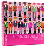 A 1000-piece jigsaw puzzle box from Puzzlfolk titled 'Nutcracker Collection'. The box features a vibrant illustration of multiple nutcracker characters in colorful historical uniforms against a light pink background, with a solid bright pink bottom section containing the product title.