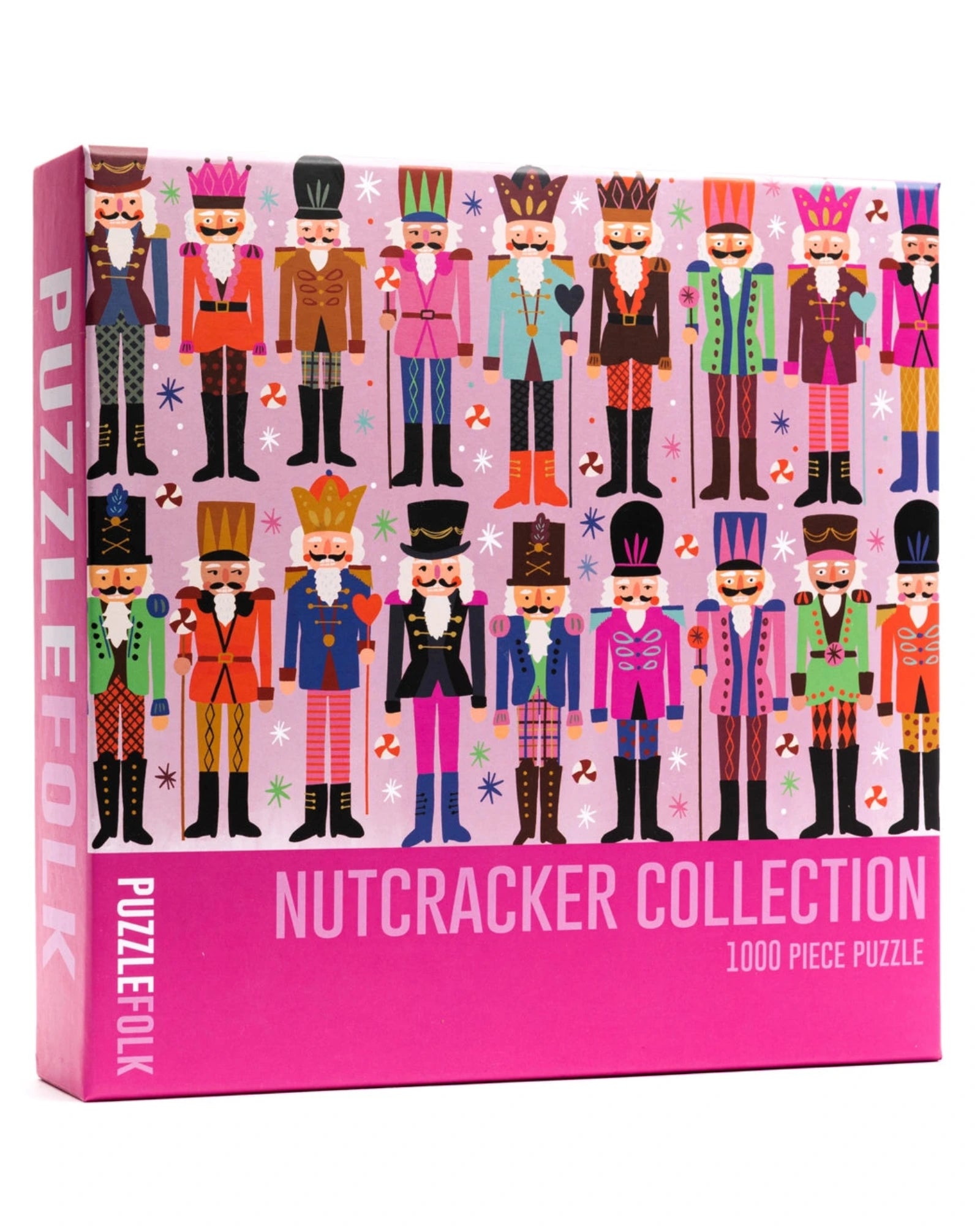 A 1000-piece jigsaw puzzle box from Puzzlfolk titled 'Nutcracker Collection'. The box features a vibrant illustration of multiple nutcracker characters in colorful historical uniforms against a light pink background, with a solid bright pink bottom section containing the product title.