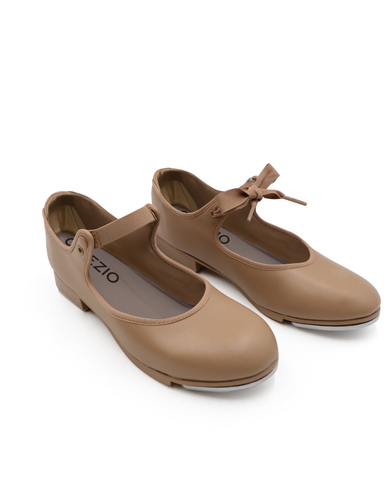 Pair of tan shoes with a bow on a white background