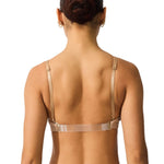 Woman wearing a beige bralette on a white background