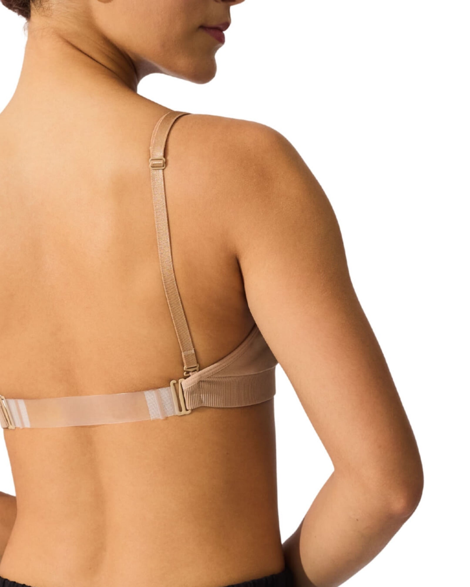 Beige bra worn by a person on a white background