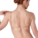 Woman wearing a beige shapewear garment on a white background