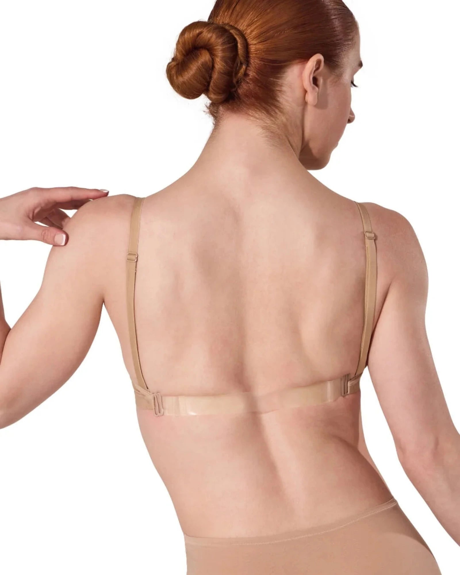 Woman wearing a beige shapewear garment on a white background
