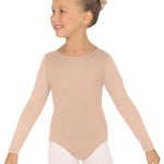 Young girl wearing a nude long-sleeve leotard and white tights on a white background