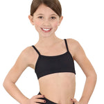 Young girl wearing a black sports bra and leggings on a white background