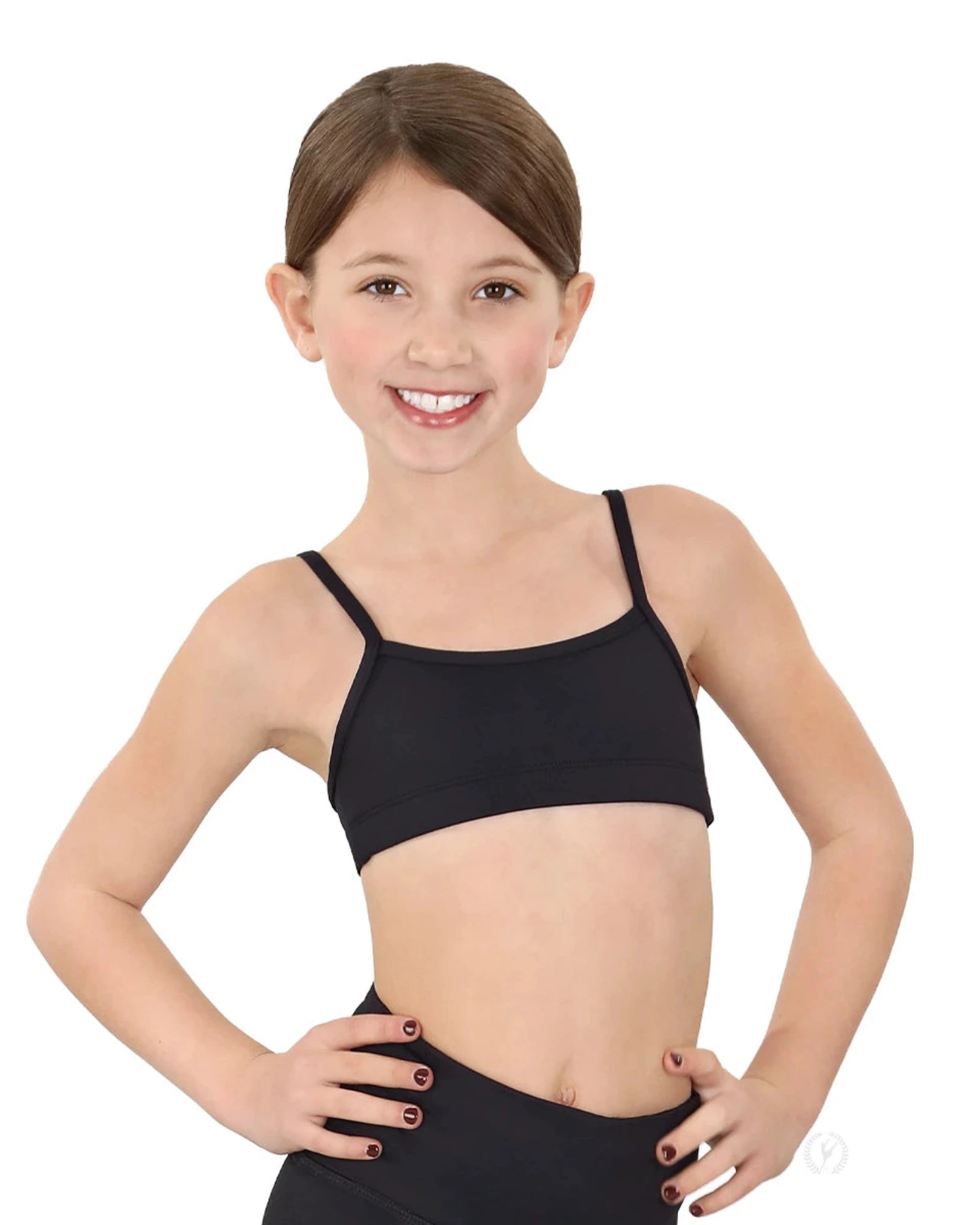 Young girl wearing a black sports bra and leggings on a white background