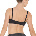 Woman wearing a black dance bra top on a white background