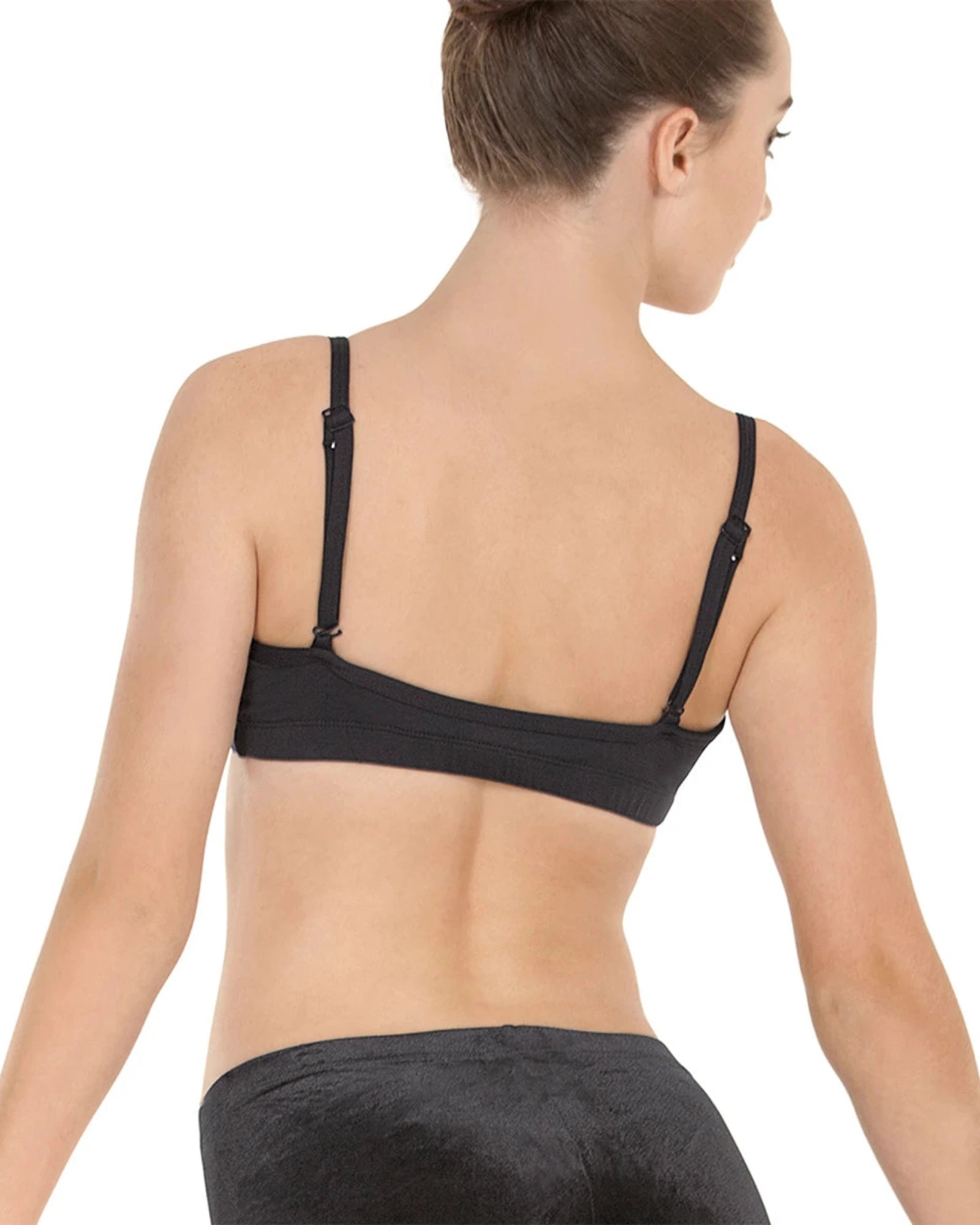 Woman wearing a black dance bra top on a white background
