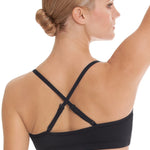 Woman wearing a black dance bra top with thin straps on a white background