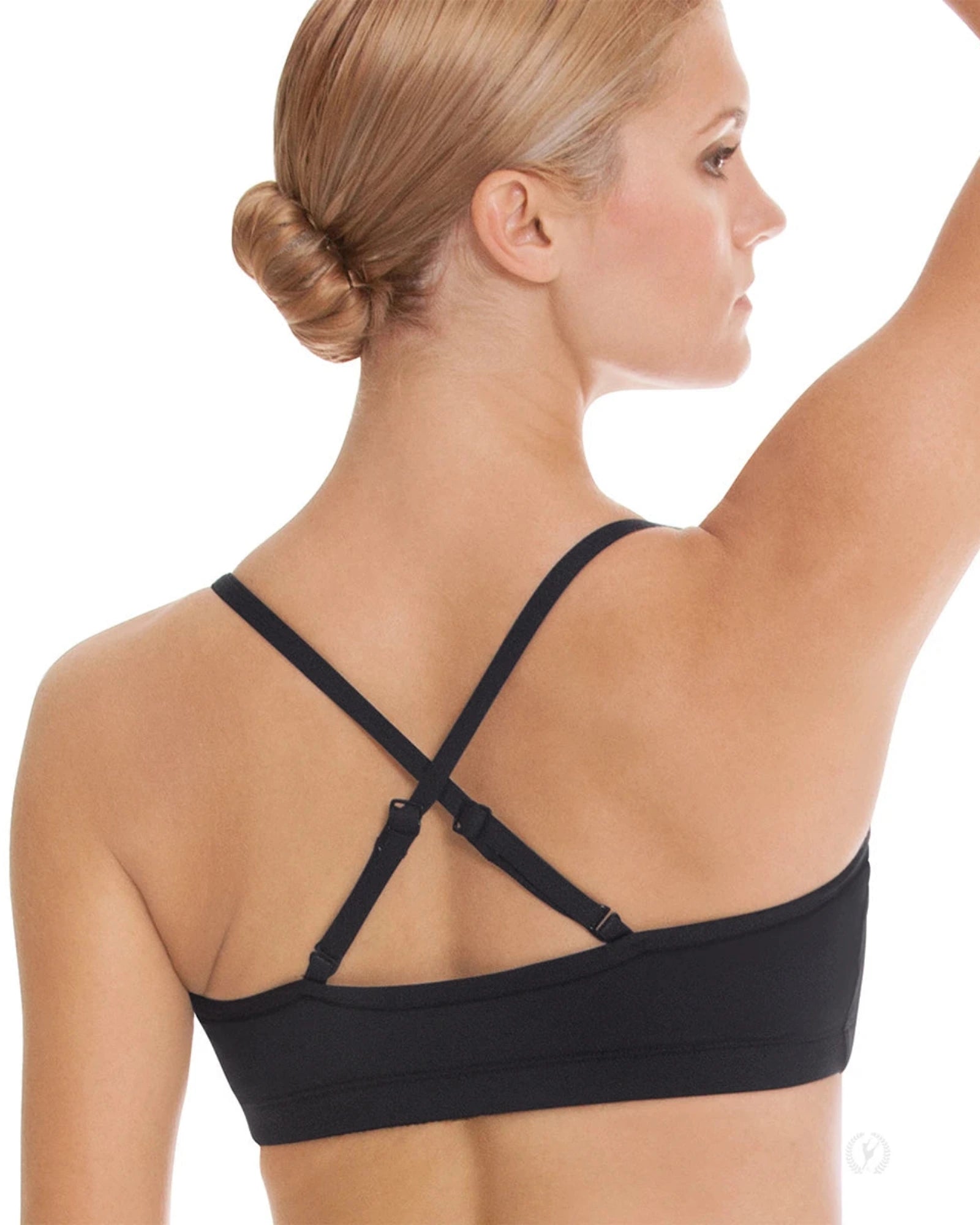 Woman wearing a black dance bra top with thin straps on a white background