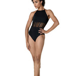 Woman wearing black leotard on white background
