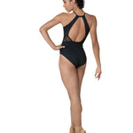 Woman wearing black leotard on white background