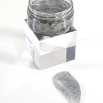Silver glitter jar with a sample on a white background
