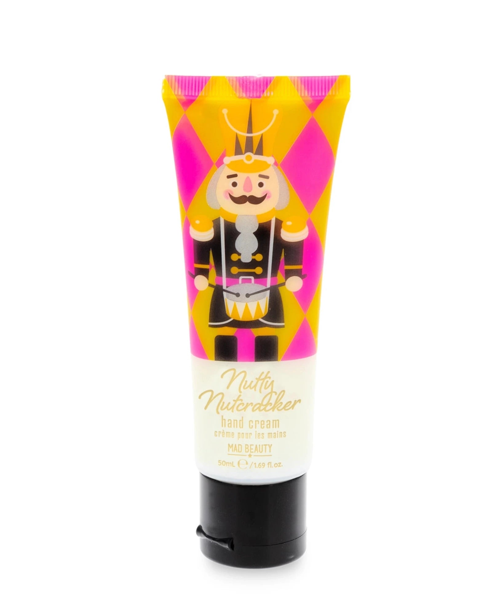 A squeeze tube of hand cream featuring a colorful nutcracker illustration on a pink and yellow harlequin pattern background, with a black flip-top cap, photographed on a plain white background.