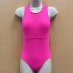 A bright pink sleeveless one-piece leotard displayed on a white mannequin torso against a light wood-paneled background.