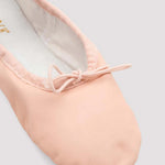 Pink ballet shoe on a light gray background