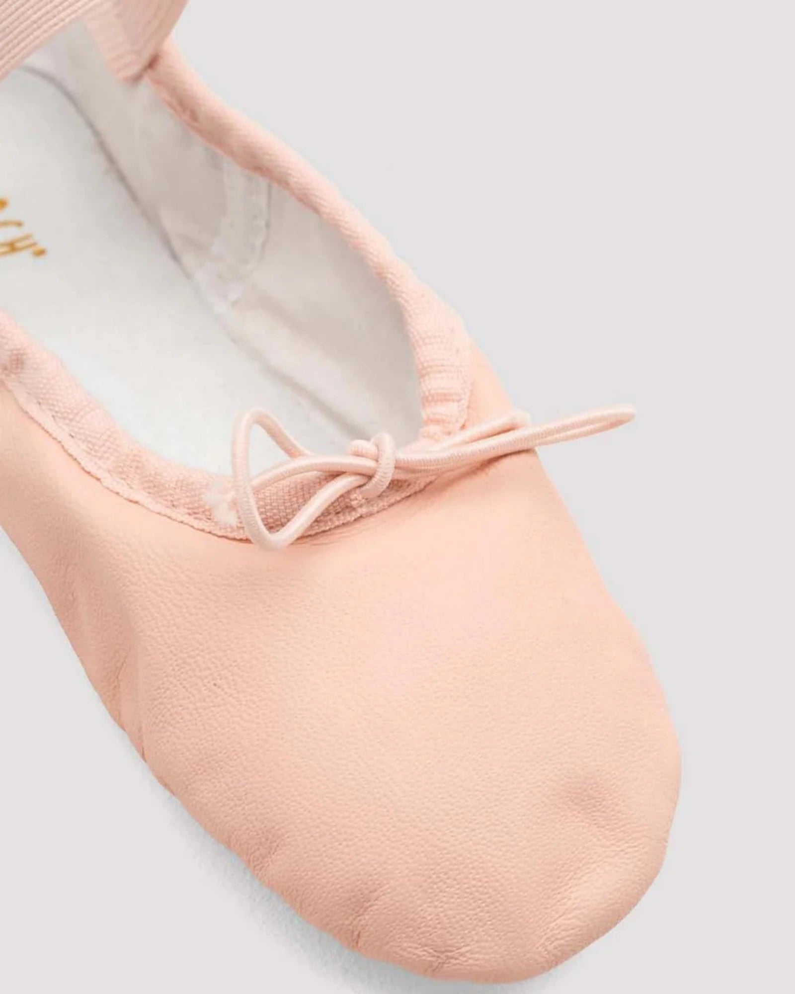 Pink ballet shoe on a light gray background