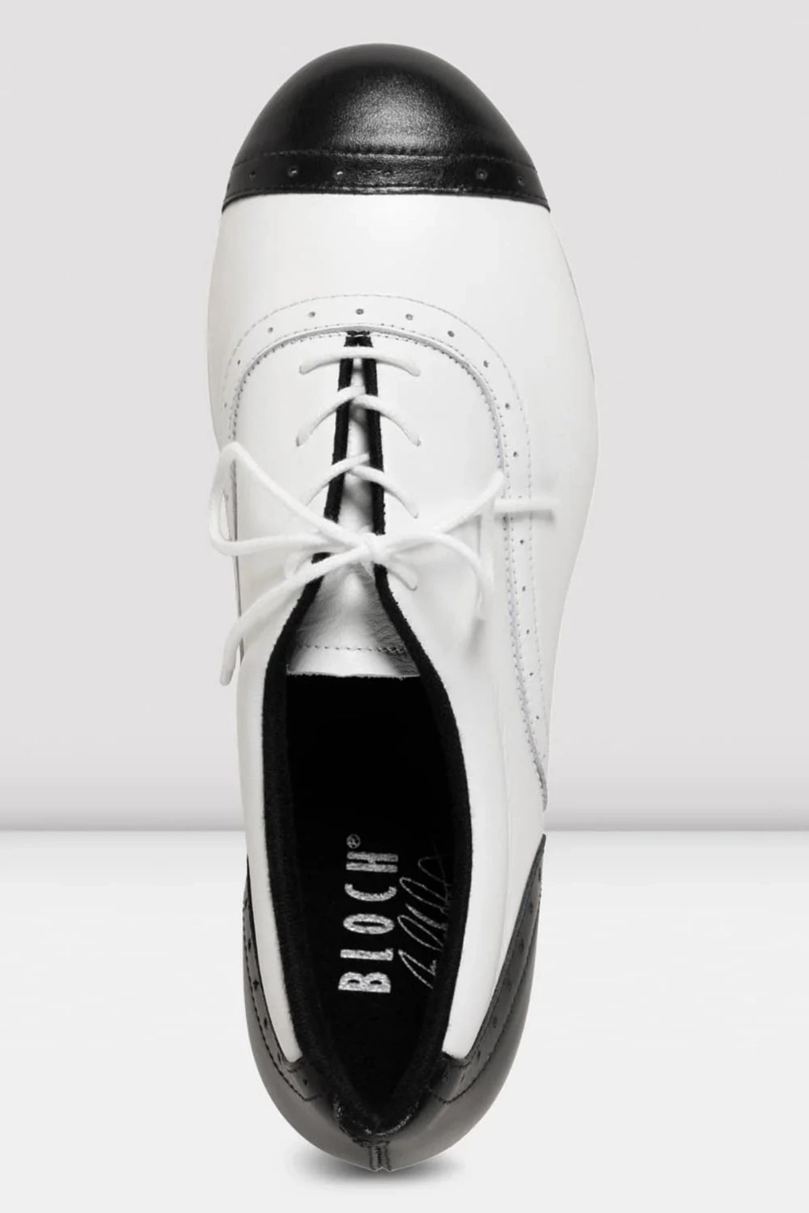 White shoe with black sole on a white background