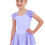 Young girl wearing a light purple leotard with sequin skirt on a white background