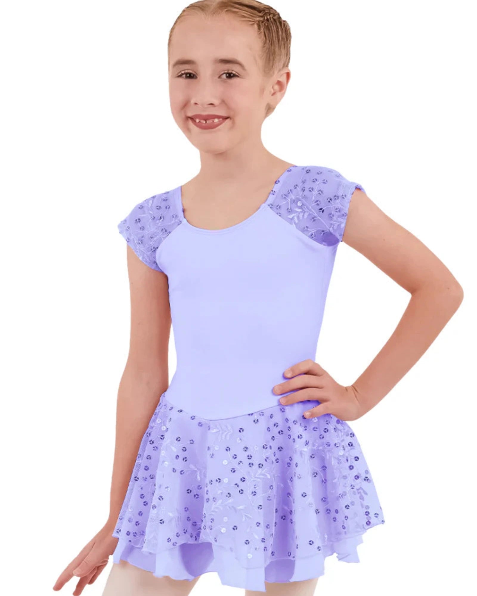 Young girl wearing a light purple leotard with sequin skirt on a white background