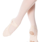 Ballet shoes worn with tights on a white background