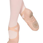 Ballet shoes worn with pink tights on a white background