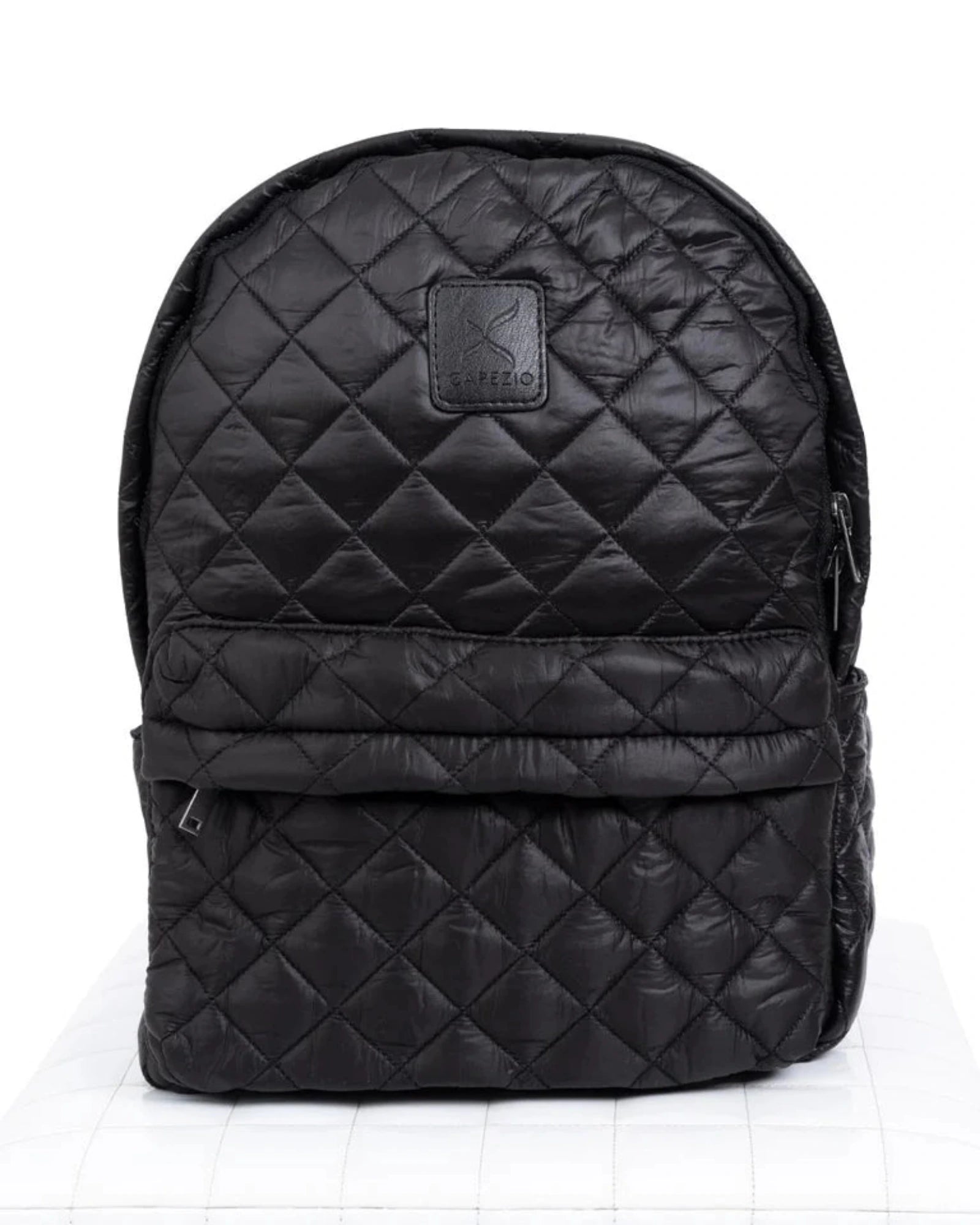 Black quilted backpack on a white background