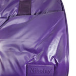 Close-up of a purple Nikolay waterproof bag with a glossy finish and a matching purple brand patch on the front, set against a plain white background.