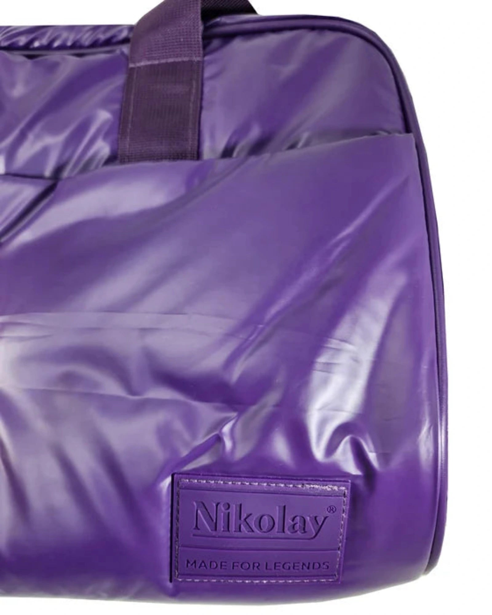 Close-up of a purple Nikolay waterproof bag with a glossy finish and a matching purple brand patch on the front, set against a plain white background.