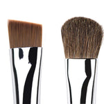 Two makeup brushes with brown bristles on a white background