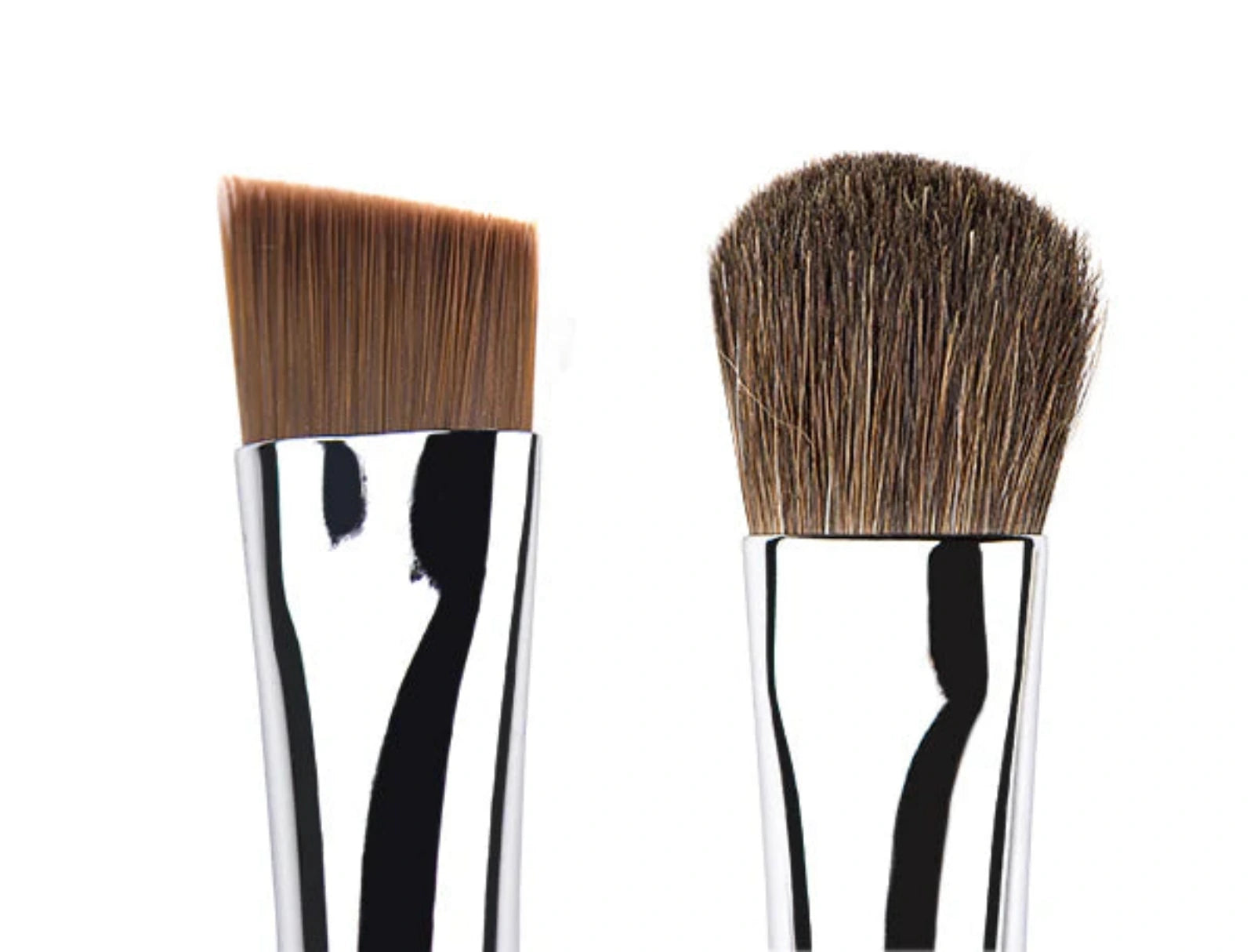 Two makeup brushes with brown bristles on a white background