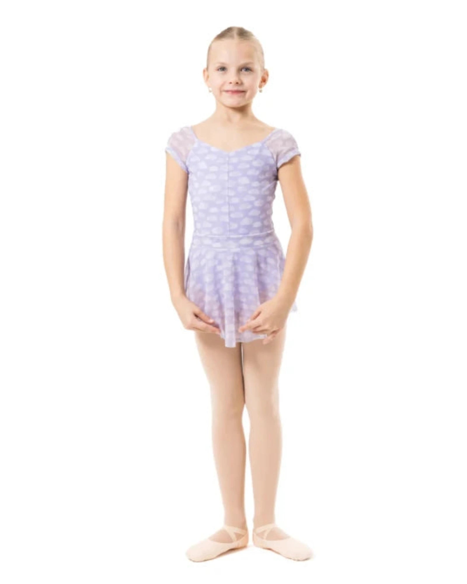 A young girl dancer standing in a light purple and white patterned leotard with matching tights and pink ballet slippers against a solid white background.