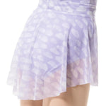 A close-up of a model wearing a lavender and white patterned mesh skirt with a sheer underlayer, shown from the waist down against a white background.