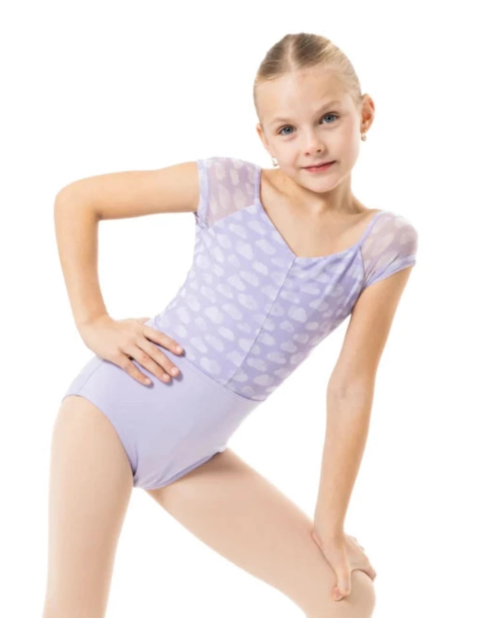 A young girl dancer posing in a light purple leotard with a subtle cloud pattern and sheer cap sleeves, set against a solid white background.