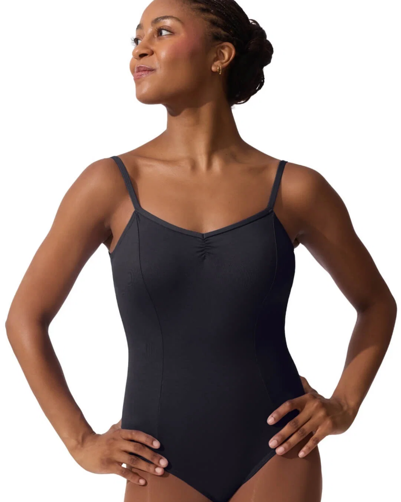 Woman wearing a black leotard on a white background