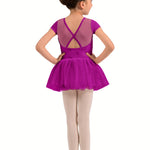 A young girl dancer shown from the back wearing a bright magenta purple short-sleeve leotard with a mesh criss-cross back and a matching tutu skirt, paired with light pink tights and ballet shoes, against a plain white background.