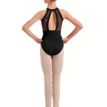 Ballerina in a black leotard with sheer details on a white background